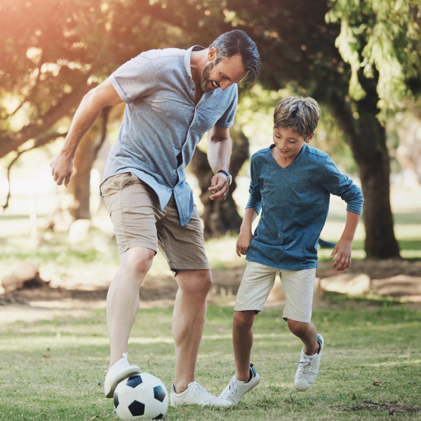 Parenting Athletes Father and son playing soccer